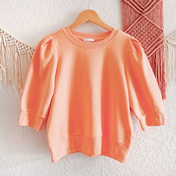 pastel orange sweatshirt
